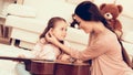 Mom with Guitar in Hand and Girl Sitting on Carpet Royalty Free Stock Photo