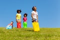 Kids hop downhill in gunny sack race game outside Royalty Free Stock Photo