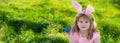 Kids hunting easter eggs. easter basket Boy with easter eggs and bunny ears in backyard. Horizontal photo banner for