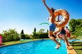 Kids with inflatable buoys dive into swimming pool Royalty Free Stock Photo