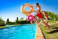 Kids with inflatable buoys jump dive into pool Royalty Free Stock Photo