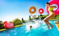 Kids with inflatable buoys splash dive into pool Royalty Free Stock Photo