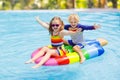 Kids on inflatable float in swimming pool Royalty Free Stock Photo