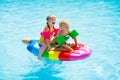 Kids on inflatable float in swimming pool Royalty Free Stock Photo