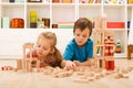 Kids inspecting their wooden block buildings