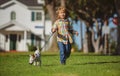 Kids insurance. Little boy kid running with dog, playing owner and pet in summer meadow. Happy Puppy. Family, parenthood