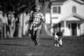 Kids insurance. Little boy kid running with dog, playing owner and pet in summer meadow. Happy Puppy. Family, parenthood