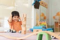 Kids intend learn from play with colorful wooden toy on table desk at home. Preschool young girl concentrating with educational bl Royalty Free Stock Photo