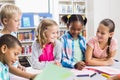 Kids interacting with each other in library Royalty Free Stock Photo