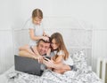 Kids interfere father freelancer work at home bed Royalty Free Stock Photo