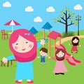 Kids Islam girls and boys having fun in park wearing veil with sliding tree Royalty Free Stock Photo