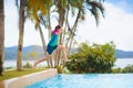 Kids jump into swimming pool. Summer water fun Royalty Free Stock Photo