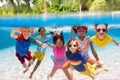 Kids jump into swimming pool. Summer water fun Royalty Free Stock Photo