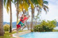 Kids jump into swimming pool. Summer water fun Royalty Free Stock Photo