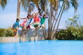 Kids jump into swimming pool. Summer water fun Royalty Free Stock Photo