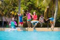 Kids jump into swimming pool. Summer water fun Royalty Free Stock Photo