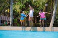 Kids jump into swimming pool. Summer water fun Royalty Free Stock Photo