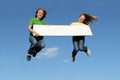 Kids jumping with blank sign Royalty Free Stock Photo