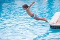 Kids jumping in pool. Happy child swimming in the pool. Royalty Free Stock Photo