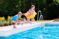 Kids jumping into swimming pool Royalty Free Stock Photo