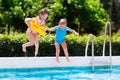 Kids jumping into swimming pool Royalty Free Stock Photo