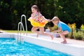 Kids jumping into swimming pool Royalty Free Stock Photo