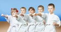 Kids in karategi are hitting punch arm Royalty Free Stock Photo