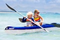 Kids kayaking in ocean. Children in kayak in tropical sea