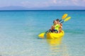 Kids kayaking in ocean. Family in kayak in tropical sea