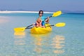 Kids kayaking in ocean. Family in kayak in tropical sea