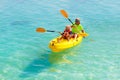 Kids kayaking in ocean. Family in kayak in tropical sea