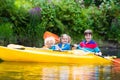 Kids kayaking on a river Royalty Free Stock Photo