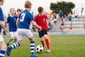 Kids Kicking Football Ball. Youth Players Kicking Soccer Match on Grass Stadium. Youth Football Tournament Royalty Free Stock Photo