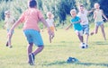 Kids kicking football in park Royalty Free Stock Photo