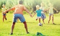 Kids kicking football in park Royalty Free Stock Photo