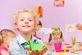 Kids in kindergarten make origami, portrait of boy