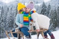 Kids kiss lovely. Kids boy and little girl enjoying a sleigh ride. Children kissing together, play outdoors in snow on Royalty Free Stock Photo