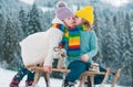 Kids kiss lovely. Kids boy and little girl enjoying a sleigh ride. Children kissing together, play outdoors in snow on Royalty Free Stock Photo