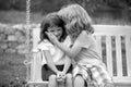 Kids kissing in summer park outdoors. Little boy and girl kids enjoying summer. Best friends two children.