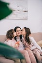 kids kissing their mother