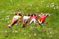 Kids lay in the grass and with color balls around Royalty Free Stock Photo