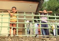 Kids leaning on railings