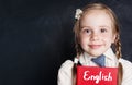 Kids learn english concept. Closeup portrait of cute child girl Royalty Free Stock Photo