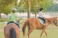 Kids learn to ride a horse near the river