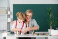 Kids learning with teacher. Children from elementary school study at lesson. Teacher and little students portrait Royalty Free Stock Photo