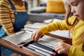 Kids life. Close up of caucasian little girl spending time with african american baby sitter. Kid is drawing using Royalty Free Stock Photo