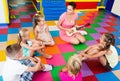 Kids listening positive teacher playing musician instrument Royalty Free Stock Photo