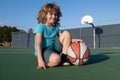 Kids little boy playing basketball. Child sport activity. Smiling boy plays ball.