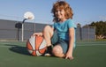 Kids little boy playing basketball. Child sport activity. Smiling boy plays ball.