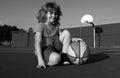 Kids little boy playing basketball. Child sport activity. Smiling boy plays ball.